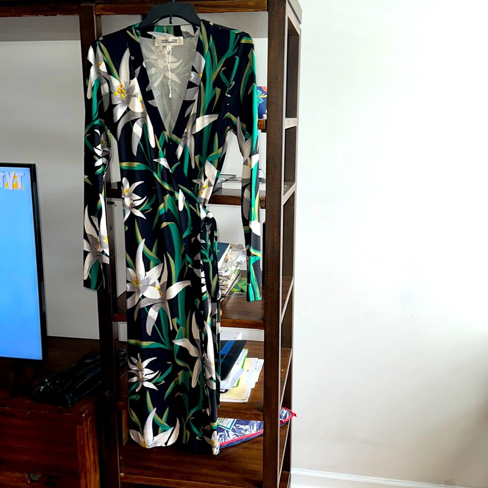 DIANE VON FURSTENBERG’s wrap dress with green, grey flowers on black.